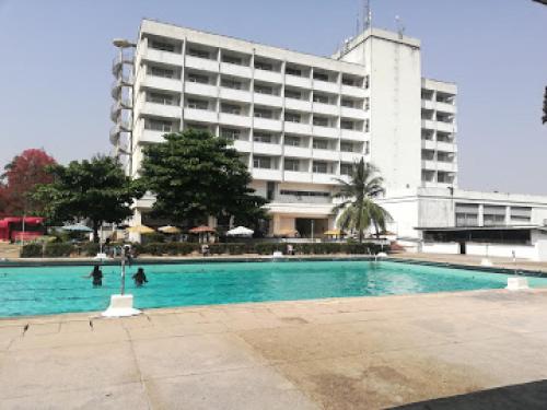 a swimming pool in front of a large building at Premier Hotel-ibadan in Ibadan