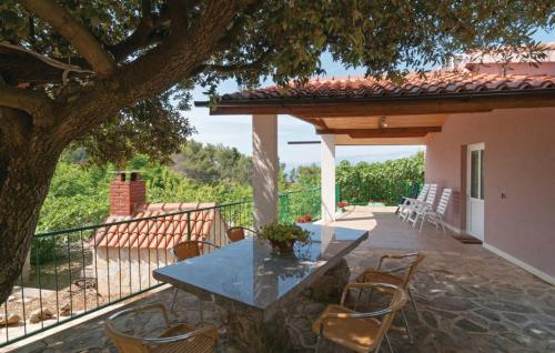 a patio with a table and chairs on a house at Holiday Home Blossom in Supetar