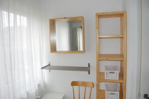 
a room with a chair and a mirror at Villa Mowgli in De Panne
