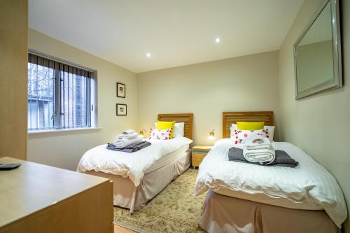 a bedroom with two beds and a window at 15 Stonegate Court in York