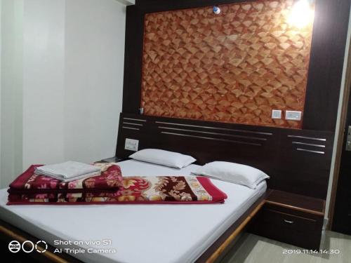 a bed in a room with at Vamoose Sujata Residency in Sundargarh