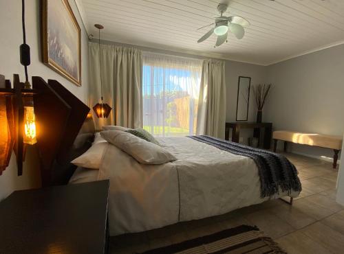 a bedroom with a large bed and a window at Francor Blouberg Beach in Cape Town