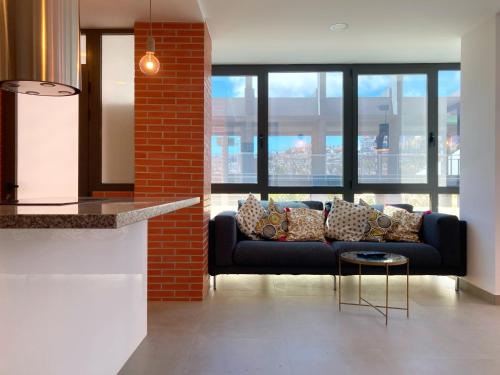 a living room with a couch and a table at Insular Luxury Beach Flat by Canary365 in Las Palmas de Gran Canaria