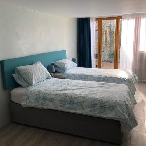 une chambre avec deux lits et une fenêtre dans l'établissement BlanzayAprtment 1bed Pool Bbq Wifi FreeP, à Blanzay
