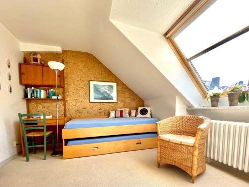 a bedroom with a bed and a desk in a attic at Haus Germania in Helgoland