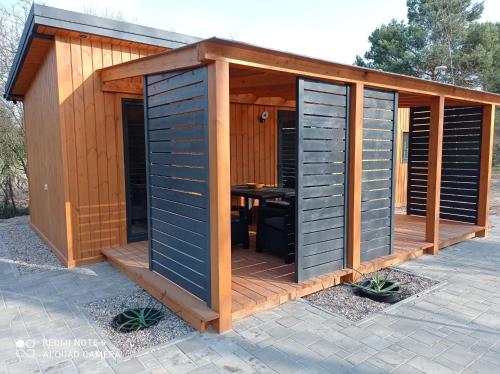 a wooden shed with a table in it at ApartDomek CICHE in Zbiczno