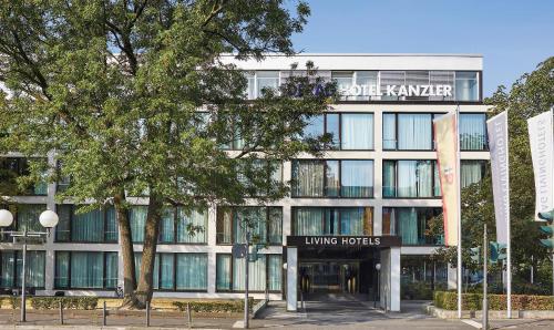 a large building with a clock on the front of it at Living Hotel Kanzler in Bonn