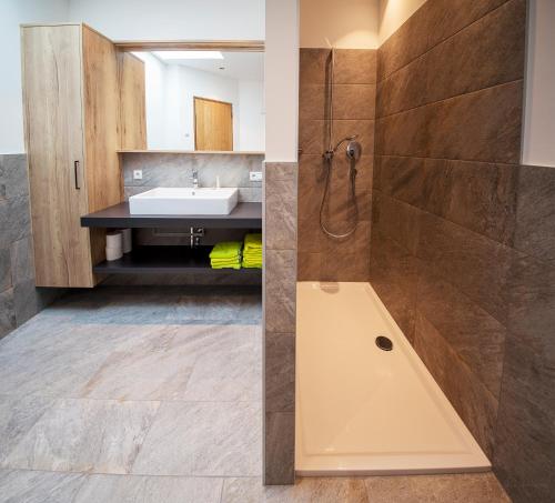 a bathroom with a sink and a shower at Camping Zögghof in San Leonardo in Passiria