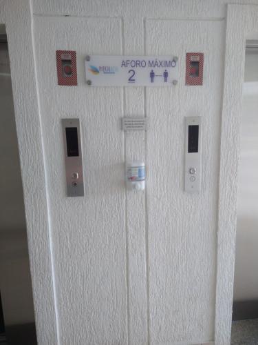 a white door with a sign on it at INCREIBLE APARTAMENTO Puerto Azul Club House RICAURTE in Ricaurte
