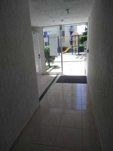 an empty hallway with an open door to a playground at INCREIBLE APARTAMENTO Puerto Azul Club House RICAURTE in Ricaurte