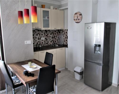 a kitchen with a table and a refrigerator at Studio Emi in Pomorie