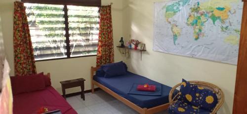 a room with a bed and a map of the world at Homestay Galpera Papua in Jayapura