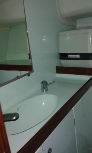 a bathroom with a sink and a refrigerator at leyliley in Portosin