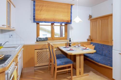 a small kitchen with a table and chairs and a window at Ferienwohnung Sonja in Elmen