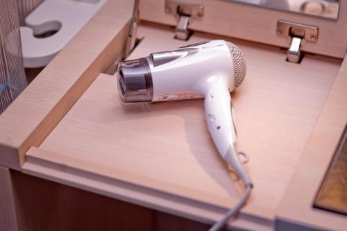 a hair dryer sitting on top of a counter at Yomi Hotel - ShuangLian MRT in Taipei