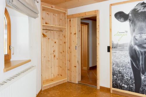 a room with a cow poster on the wall at Ferienwohnung Sonja in Elmen