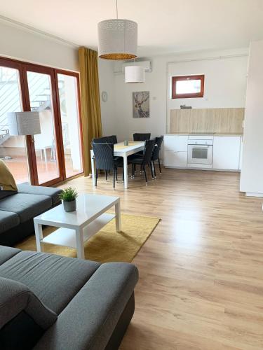 a living room with a couch and a table at Happy Mammy Bababarát Vendégház Fészek utca in Orosháza
