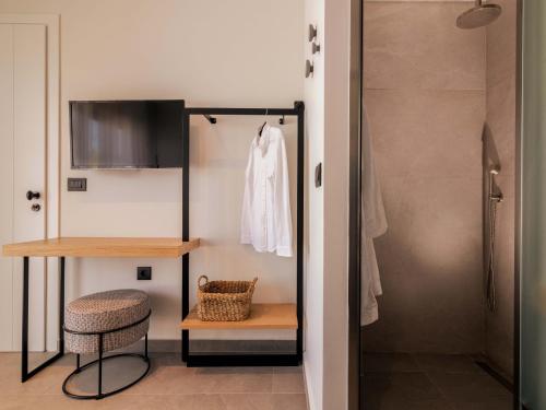 a bathroom with a walk in shower and a stool at ELYSIAN VILLA in Amoudi