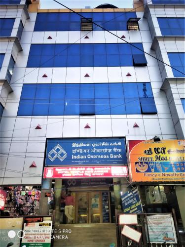 a tall building with signs in front of it at Hotel Temple View Annex in Madurai