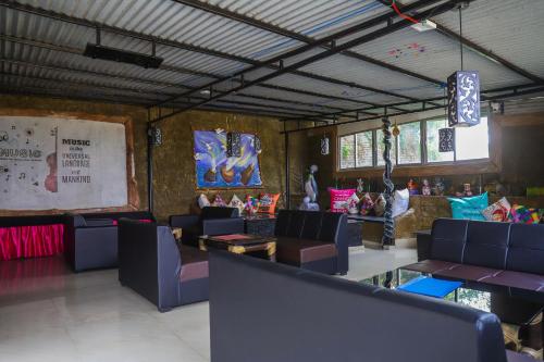 a restaurant with couches and tables in a room at Dungmali Heritage Resort in Namchi