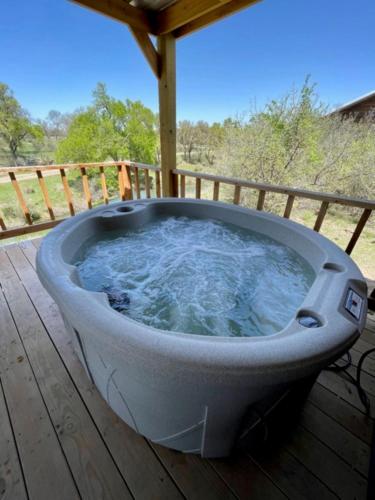a bath tub sitting on top of a wooden deck at City on a Hill at Spring Creek in Fredericksburg