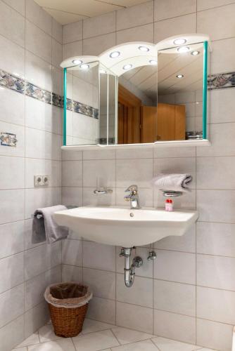 a bathroom with a sink and a mirror at Ferienwohnung Sonja in Elmen