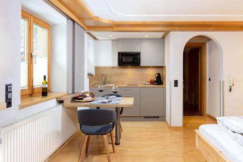 a small kitchen with a table and a bed at Ferienwohnung Sonja in Elmen