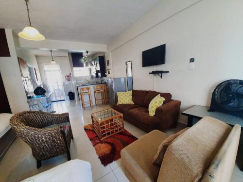 a living room with a couch and a table at Marlborough Durban Beachfront South Beach luxury Holiday Apartments on Marine Parade! in Durban
