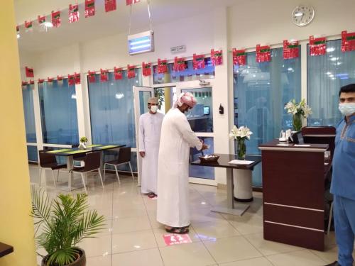 a group of men standing in a room at City Hotel Duqm in Duqm