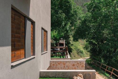 a building with a staircase next to a house at Rifugio del Gran Sasso in Assergi