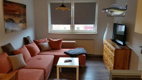 a living room with a couch and a tv at Fewo Helmstedt in Helmstedt