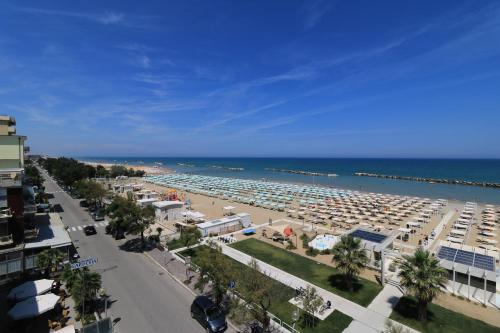 a view of a beach with white buildings and the ocean at Hotel Ida in Rimini