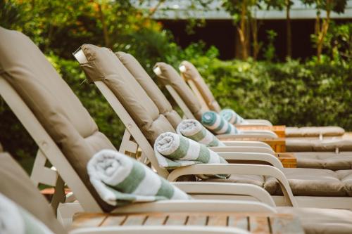 a row of lawn chairs lined up next to each other at Airport Planet Lodge in Kingori