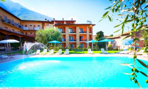 a swimming pool in front of a hotel at Hotel Villa Isabella in Brenzone sul Garda