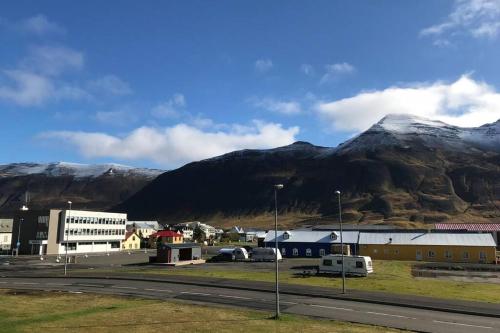 a small town with a mountain in the background at House with a warm soul in North Iceland in Siglufjörður