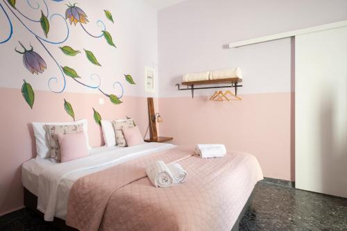 a bedroom with two beds with towels on them at Kalamata Art Rooms in Kalamata