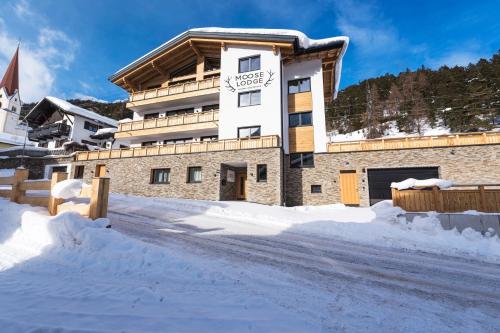 a large building in the snow with a snowy road at Moose Lodge in Sankt Anton am Arlberg