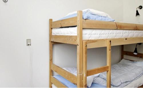 a couple of bunk beds in a room at On the beach Apartment in Brenderup