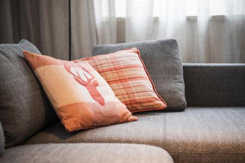 a pillow with a hand on it sitting on a couch at Moose Lodge in Sankt Anton am Arlberg