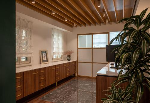 a large bathroom with wooden cabinets and a potted plant at Its Kale Boutique Hotel in Ioannina