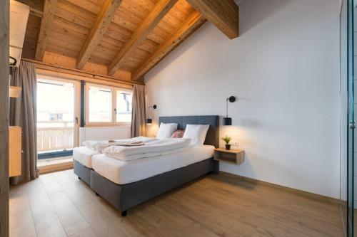 1 dormitorio con cama grande y ventana grande en Moose Lodge, en Sankt Anton am Arlberg