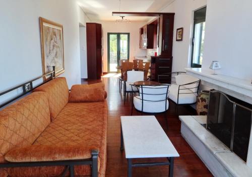 a living room with a couch and a table at Dionysos Hotel in Skala