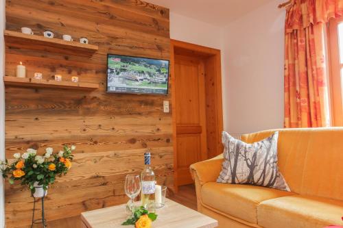 a living room with a couch and a table at Chalet Eder in Leogang