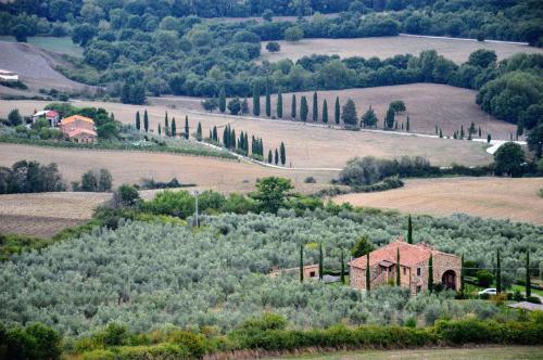 an aerial view of a house on a hill with trees at Il Girasole Terzuolo in Manciano