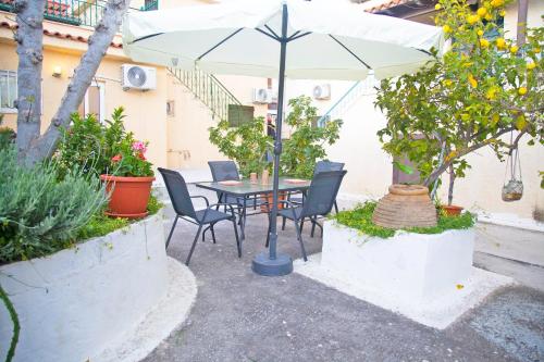 a patio with a table and chairs and an umbrella at Areopolis Art in Areopolis