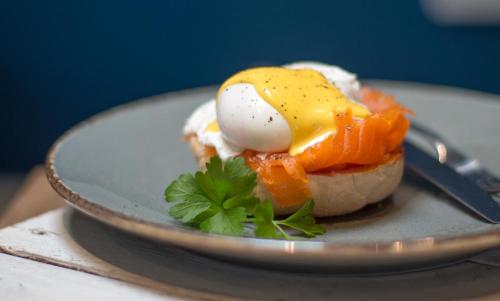 a plate of food with an egg and fruit at The Ferry Boat Inn in North Fambridge