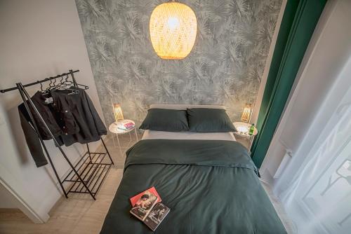 a bedroom with a bed and a chandelier at Apartamenty Rejtana in Leszno