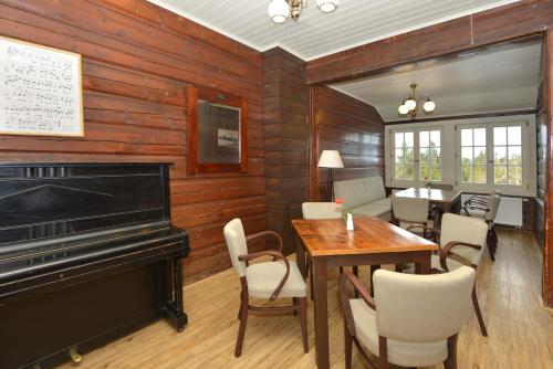 a living room with a piano and a table and chairs at Prezidentská in Bedřichov