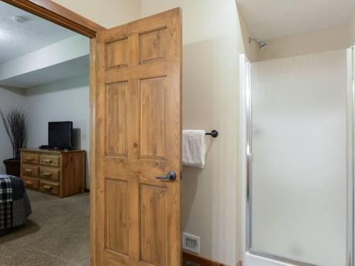 a bathroom with a wooden door and a shower at Lodge 371 in Branson