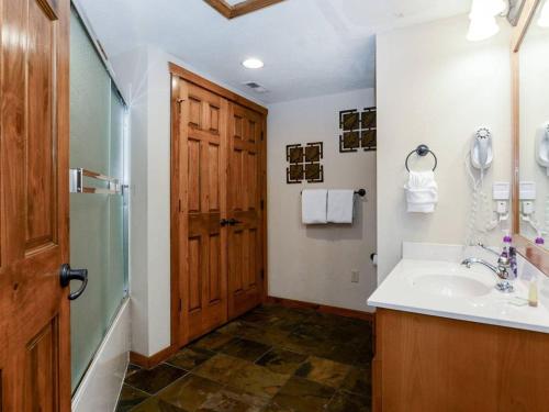 a bathroom with a sink and a shower and a mirror at Lodge 371 in Branson